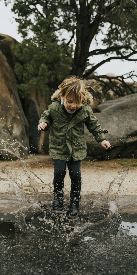 image of a small child playing in a puddle