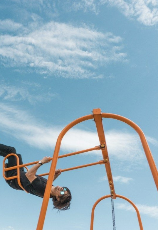 a person on an orange swingset
